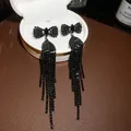 Elegant black rhinestone long tassel earrings with bow accents on a white luxury jewelry box - Bowknot Tassel Style (35#)
