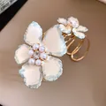 Elegant gold-tone bracelet featuring white wrinkled flowers with pearls and crystals. - Enamel Texture Stereo Flower Style / White and Blue