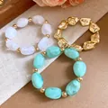 Close-up detail of irregular geometric acrylic and metallic gold beads on elastic bracelets - Irregular Beaded Bracelet Set / Gold-Cyan-Transparent
