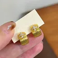 Close-up of 18k gold plated cross hoop earrings with sparkling cubic zirconia - Gold (Real Gold Plated)