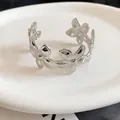 Elegant silver metal cuff bracelet with a hollowed wrinkled flower petal design - Sequential Flower Pleated Style / Silver