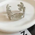 Elegant silver-toned metal cuff bracelet featuring a detailed wrinkled floral petal design - Continuous Five-Petal Flower Pleated Style / Silver
