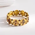 Close-up of vintage gold and bronze bracelet with religious cross and fish motifs - Gold
