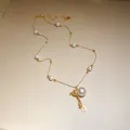 Detail view of 14k gold plated necklace with pearl gourd pendant and lucky coin - Gourd Pendant (HN11398) / Gold