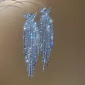 Elegant silver-tone rhinestone tassel drop earrings with sparkling starburst effect. - Crown Tassel Style (31#)