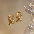 Close-up detail of 18K gold plated waterdrop earrings featuring butterfly zircon - Gold