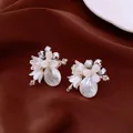 Elegant white flower water drop earrings with silver beads on brown silk background. - Style 9