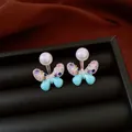Elegant butterfly stud earrings with colorful zircon and pearl details in light blue - Style 18
