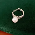 Close-up of elegant white pearl open ring with shimmering zircon-paved band detail - Open Ring / Silver-White