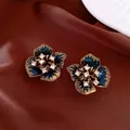 Vintage style blue enamel flower stud earrings with shimmering cubic zirconia centers. - Style 30