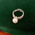 Close-up detail of silver open ring with large pearl and sparkling pavé zircons - Open Ring / Silver-Grey