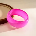 Macro detail showing the iridescent glitter inside a bright pink resin geometric bangle - Rose Red