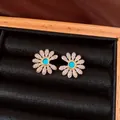 Elegant gold-plated daisy stud earrings with turquoise center and pavé cubic zirconia - Style 31