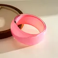 Detailed macro view of a translucent pink resin bangle with a shimmering glitter core finish - Pink