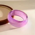 Macro detail of a translucent purple resin bangle with iridescent galaxy glitter finish - Purple