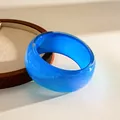 Close-up of a vibrant blue glitter resin chunky bangle with a smooth geometric design - Blue