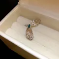 Macro view of textured silver butterfly wing ear cuff with green baguette gemstone - Green Butterfly Wing / Single Piece / Silver