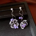 Elegant silver needle flower earrings featuring purple beads and sparkling zircon studs. - Style 41