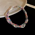 Close-up macro view of multi-layered silver-tone bracelet with vibrant colorful rhinestones. - Colorful Silver