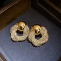 Close-up of vintage-style gold earrings with mesh twisted flower design and crystal details - Retro Flower Style (HE32862) / Silver Needle / Gold