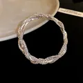 Close-up of a silver-toned multilayer rhinestone wrap bracelet with twisted design - Silver