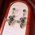 Elegant vintage floral drop earrings featuring emerald green crystals and antique gold finish - Style 45