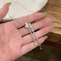 Detailed view of a French style silver necklace with pearls and sparkling cubic zirconia - Silver