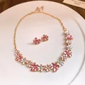 Macro view of a sweet pink and white enamel flower necklace and stud earrings set - Necklace + Earrings Set / Pink