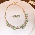 Close-up of green and white enamel flower necklace and matching stud earring set - Necklace + Earrings Set / Green