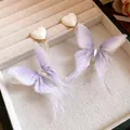 Detailed macro view of delicate purple mesh butterfly wings and white heart stud earrings - Butterfly Pendant Style (HE32573) / Purple and White