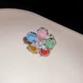 Close-up of a sparkling flower ring with colorful gemstones and zircon center - Multicolor Zirconia Flower Ring