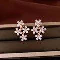 Elegant floral stud earrings with sparkling cubic zirconia crystals in gold-plated settings - Style 55