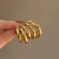 Multi-layer C-shape gold earrings with black polka dot details - Gold
