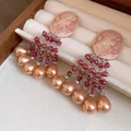 Detailed view of vintage cameo earrings with peach pearl tassels in a display box - Lady Cameo Tassel Style (HE33403) / Silver Needle-Pink-Coffee