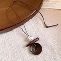 Detail view showing the intricate texture of the ethnic style resin and wood pendant. - Large Round Disc Resin Style