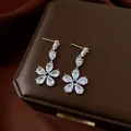 Elegant silver-tone drop earrings with delicate flower design and sparkling zircon stones - Style 66