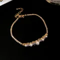 Detailed macro view of 18k gold plated bracelet with pearls and sparkling zircons - Pearl and Zirconia Style / Gold