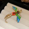 Detailed view of a vintage bird brooch with colorful enamel and sparkling rhinestones - Vintage Palace Style Bird Brooch / Colorful
