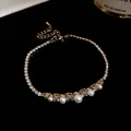 Close-up of 18k gold plated bracelet with sparkling zircons and elegant white pearls - Pearl and Zirconia Style / Silver