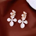Elegant white enamel flower stud earrings with zircon center and golden finish edges - Style 75
