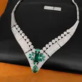 Close-up view of a vintage court-style necklace with emerald stones and paved zircons - Silver-Blue