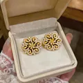 Detail view of 18K gold plated flower earrings with zircon stones in jewelry box - Flower Style (HE33880) / Gold