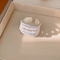 Detailed close-up of a minimalist silver multi-layer open ring with brushed texture - Silver