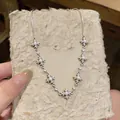 Detailed view of silver-tone cross necklace with elegant pearls and crystal accents - Necklace - Silver