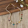 Elegant pearl necklace with colorful glass pendants on a rustic wooden background - Gold White Necklace (Multicolor Pendant)