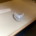 Close-up of a sparkling starfish-shaped open ring encrusted with cubic zirconia - V-Shape Pave Style (Style 2) / Silver