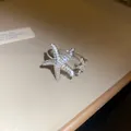 Close-up of a shimmering silver starfish open ring featuring delicate micro-paved crystals - Starfish Shape (Style 1) / Silver