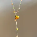 Dainty necklace featuring a dried yellow rose bud and multi-colored translucent crystal beads - Yellow