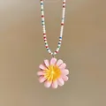 Dettaglio di un ciondolo a margherita rosa su una collana di perline colorate estiva - Rosa Multicolore