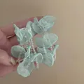 Detailed close-up view of seafoam green fabric flower drop earrings with clear beads - Floral Beaded Long Style